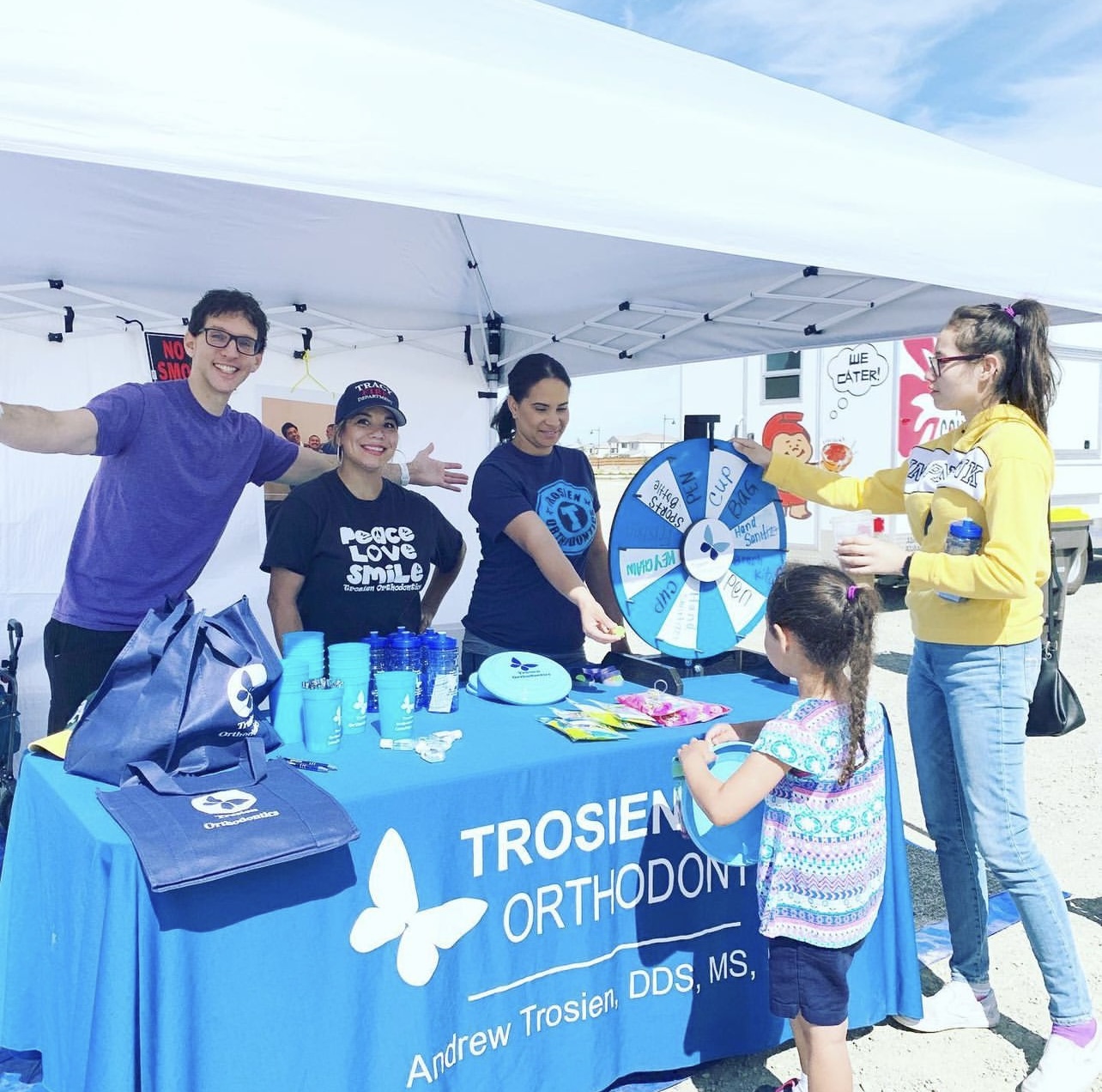 Trosien Orthodontics staff behind an information table at a community event