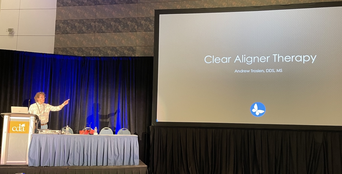 Dr Trosien addressing the audience during a conference speech on the subject of Clear Aligner Therapy
